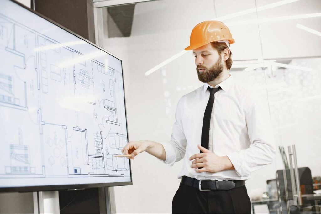 Construction professional presenting floor plans